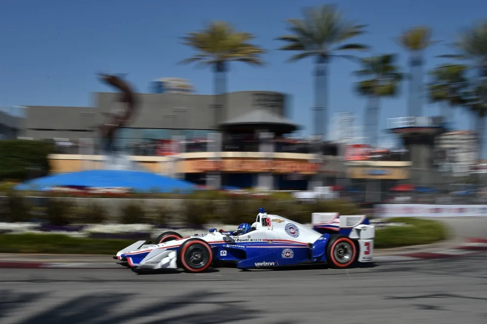 Helio Castroneves among palm trees