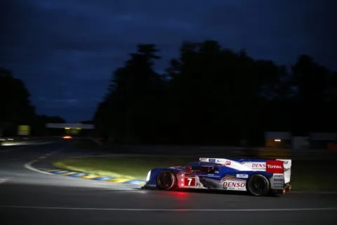 The Toyota drives into the night