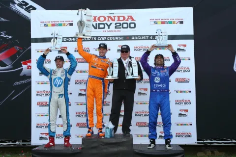 The podium: Simon Pagenaud, Charlie Kimball, Chip Ganassi and Dario Franchitti