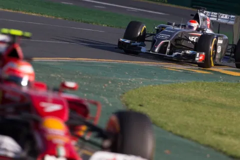 Kimi Raikkonen in front of Adrian Sutil during free practice